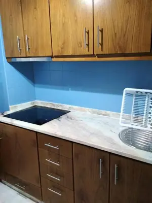 a kitchen with a sink and wooden cabinets at AlfandegaPorto Apartments in Porto