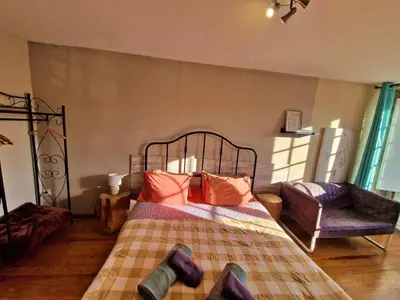 a bedroom with a bed with orange pillows and a chair at AlfandegaPorto Apartments in Porto