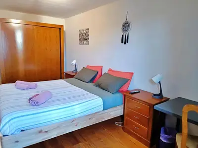 a bedroom with a bed with pink pillows on it at AlfandegaPorto Apartments in Porto