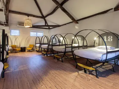a row of beds in a room with wooden floors at The House of Sandeman in Vila Nova de Gaia