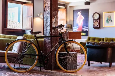 a bike parked in a room next to a couch at The House of Sandeman in Vila Nova de Gaia