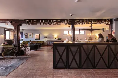 a bar in a room with people sitting at tables at The House of Sandeman in Vila Nova de Gaia
