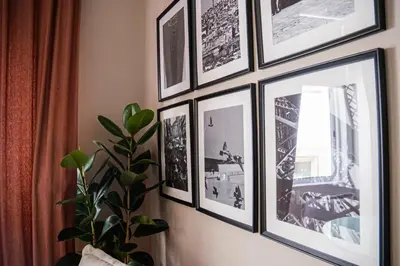 a group of pictures hanging on a wall at Impar Triplex House in Porto