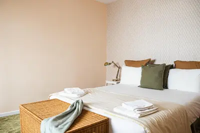 a bedroom with a large bed with towels on it at Impar Triplex House in Porto