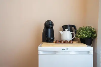 a coffee maker sitting on top of a refrigerator at Impar Triplex House in Porto