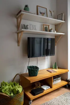 a living room with a television on a wooden stand at Virtudes Patio in Porto