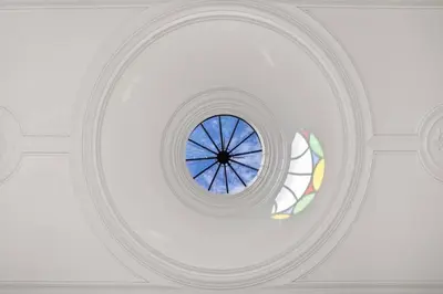 a round window in a white ceiling with a stained glass window at HeartMade Loft & Heartmade Studio in Porto
