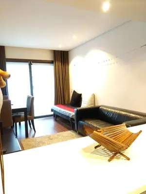 a living room with a leather couch and a chair at PATH Dukes Apartment in Porto