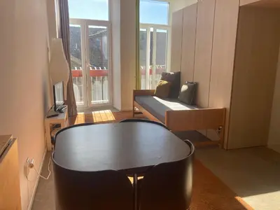 a living room with a table and a couch at PATH Biblioteca Apartment in Porto