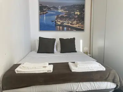 a bedroom with a bed with two towels on it at PATH Biblioteca Apartment in Porto