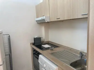 a small kitchen with a sink and a stove at PATH Biblioteca Apartment in Porto
