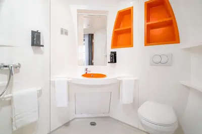 a white bathroom with a toilet and a sink at STAYSOME Porto Herculano in Porto