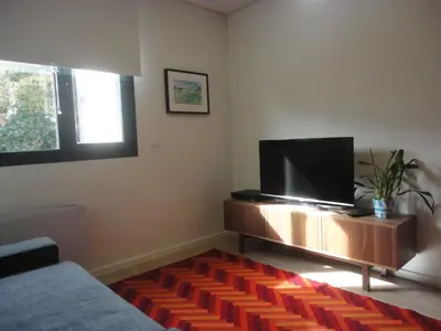 a living room with a flat screen tv on a stand at Oporto Like Home II in Porto