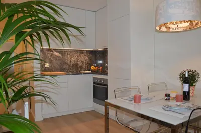 a kitchen with a table and a table and a plant at Oporto Like Home II in Porto