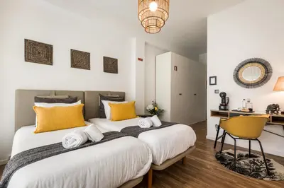 a bedroom with a large white bed with yellow pillows at Porto Essence in Porto
