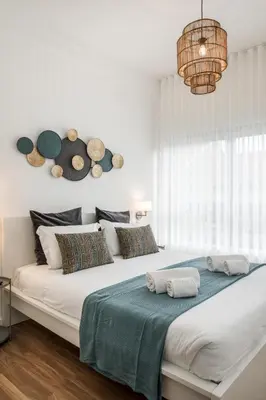 a bedroom with a large bed with hats on the wall at Porto Essence in Porto