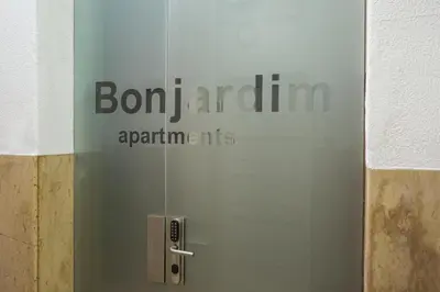 a glass door with the words bon juanaarmaarmaauts on it at Porto Bonjardim Apartments in Porto