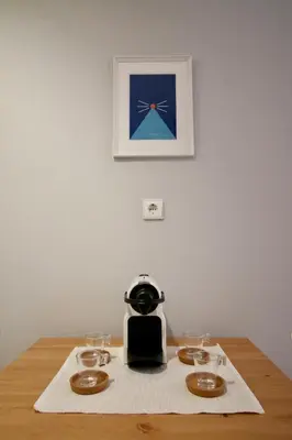 a table with a coffee maker and glasses on it at D&S - Lapa 32 in Porto