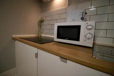 a microwave sitting on a counter in a kitchen at D&S - Lapa 32 in Porto