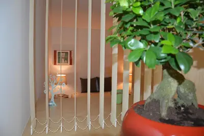 a plant in a red pot next to a fence at Oporto Like Home IV - Mezzanine in Porto