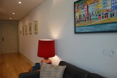 a living room with a couch and a red lamp at Oporto Like Home IV - Mezzanine in Porto