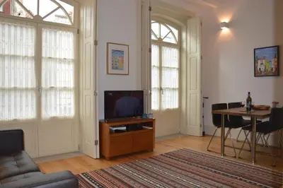 a living room with a television and a table at Oporto Like Home IV - Mezzanine in Porto