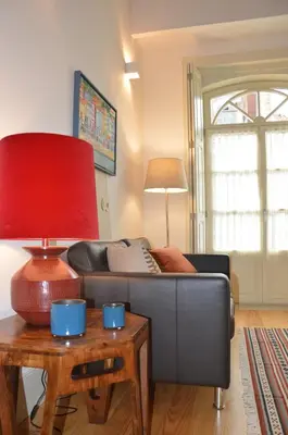 a living room with a couch and a red lamp at Oporto Like Home IV - Mezzanine in Porto