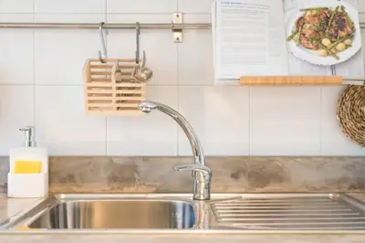a kitchen counter with a sink and a plate of food at GuestReady - Cn Apartment in Porto