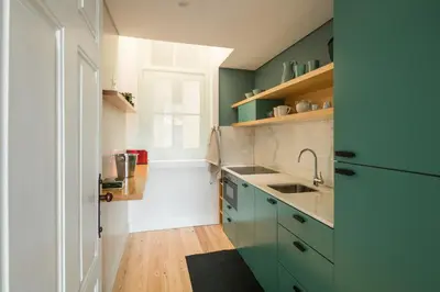 a kitchen with green cabinets and a sink at Visconde Mezzanine in Porto