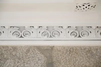 a white fireplace mantle with a white carving on it at Turista Da Trindade in Porto
