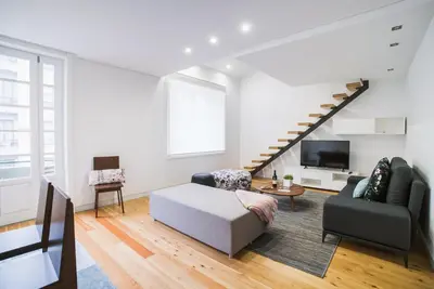 a living room with a couch and a tv at D'Autor Apartments Sá da Bandeira in Porto