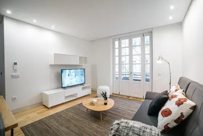 a living room with a couch and a tv at D'Autor Apartments Sá da Bandeira in Porto