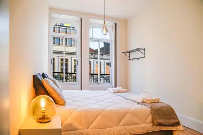 a bedroom with a large bed and a window at METRO APARTMENT in Porto