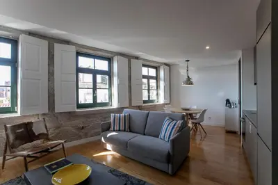 a living room with a couch and a table at Modern 18th Century Flat in Porto