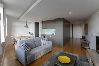 a living room with a couch and a table at Modern 18th Century Flat in Porto