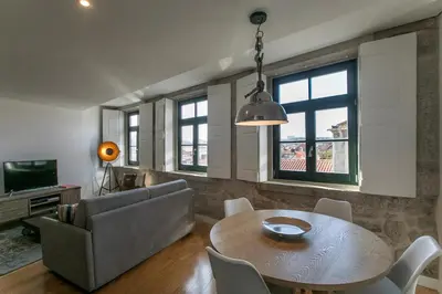 a living room with a table and a couch at Modern 18th Century Flat in Porto