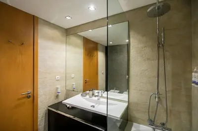 a bathroom with a sink and a shower at Comfy Luxury Apartment in Porto