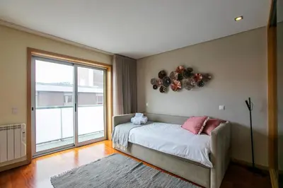 a bedroom with a bed with balloons on the wall at Comfy Luxury Apartment in Porto