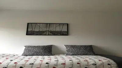 a bed with two pillows and a picture on the wall at Cocooning Appartement in Porto