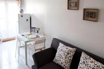 a living room with a couch and a table at apartment with balcony in the square in Porto
