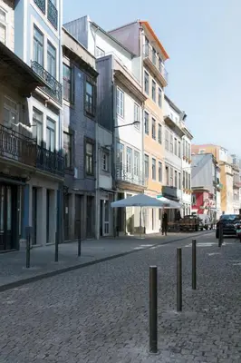 an empty city street with buildings and an umbrella at BOUTIQUE Rentals - Little Treasure Studio in Porto