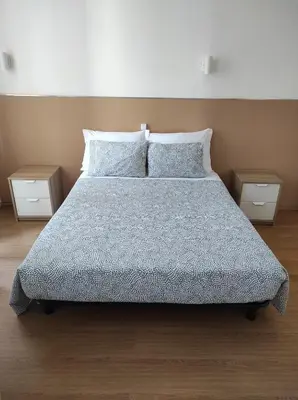 a bedroom with a bed with two night stands at Lira Guest House B&B in Porto