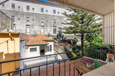 a kitchen with blue cabinets and two stools at São Miguel 50 in Porto