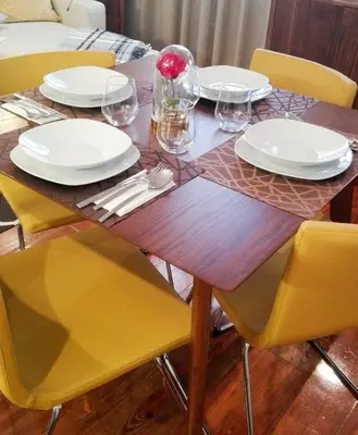 a wooden table with white plates and glasses on it at Porto Feeling in Porto