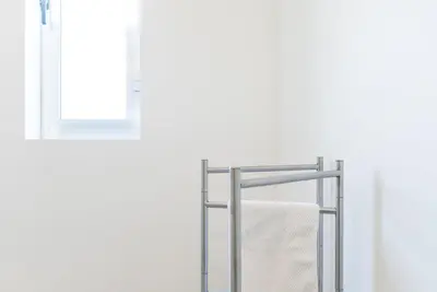 a towel rack in a bathroom next to a window at GuestReady - Theater Apartment in Porto