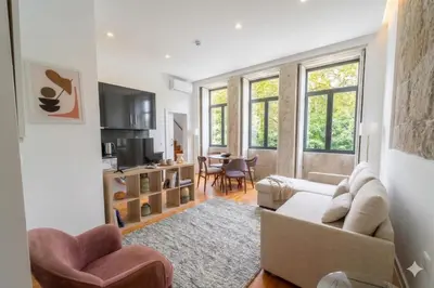 a living room with a couch and a table at Oporto City View - São Lázaro in Porto