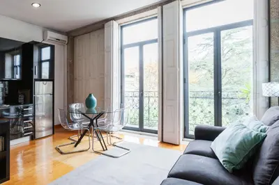 a balcony with a table next to a door at Oporto City View - São Lázaro in Porto