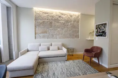 a living room with a couch and a table at Oporto City View - São Lázaro in Porto
