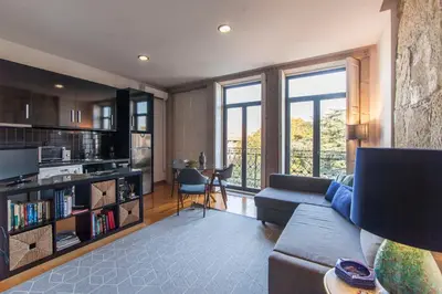 a living room with a couch and a table at Oporto City View - São Lázaro in Porto