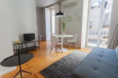 a room with two beds and a table and a lamp at Oporto City View - Santo Ildefonso in Porto